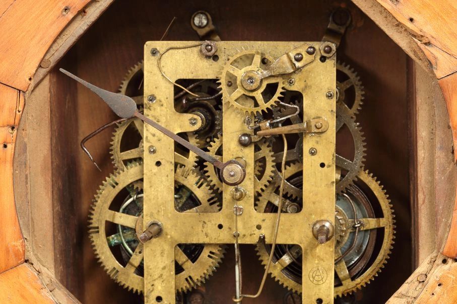 Inside of a clock showing its brass movement and gears