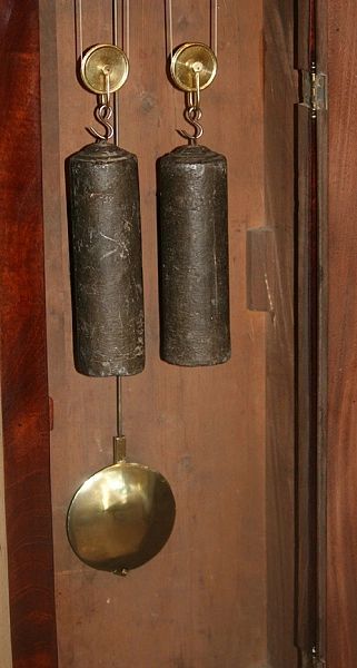 Brass weights and pendulum inside a grandfather clock